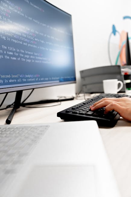 A close-up view of a computer screen displaying a code editor with HTML and CSS code. The code includes tags such as <html>, <head>, <title>, and <link>, with syntax highlighted in various colors like